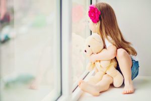 Child sitting in front of a Low-E glass window